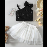 Black sequin crop top with bow and white tulle skirt