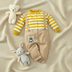 A baby romper with full sleeves and legs, beige in color with yellow stripes and a logo on the lower right leg.