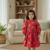 A belted frock dress with ruffle trim and a floral print pattern in pink and blue colors.