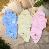 Three hooded baby winter dresses in blue, yellow, and pink colors