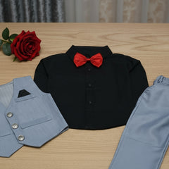 Black shirt with a red bow tie, blue vest, and pants on a wooden surface.