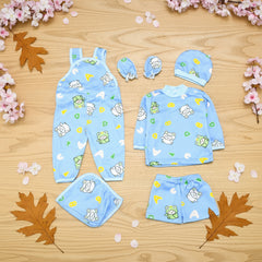 Baby clothing set with romper, hat, and diaper on a wooden surface