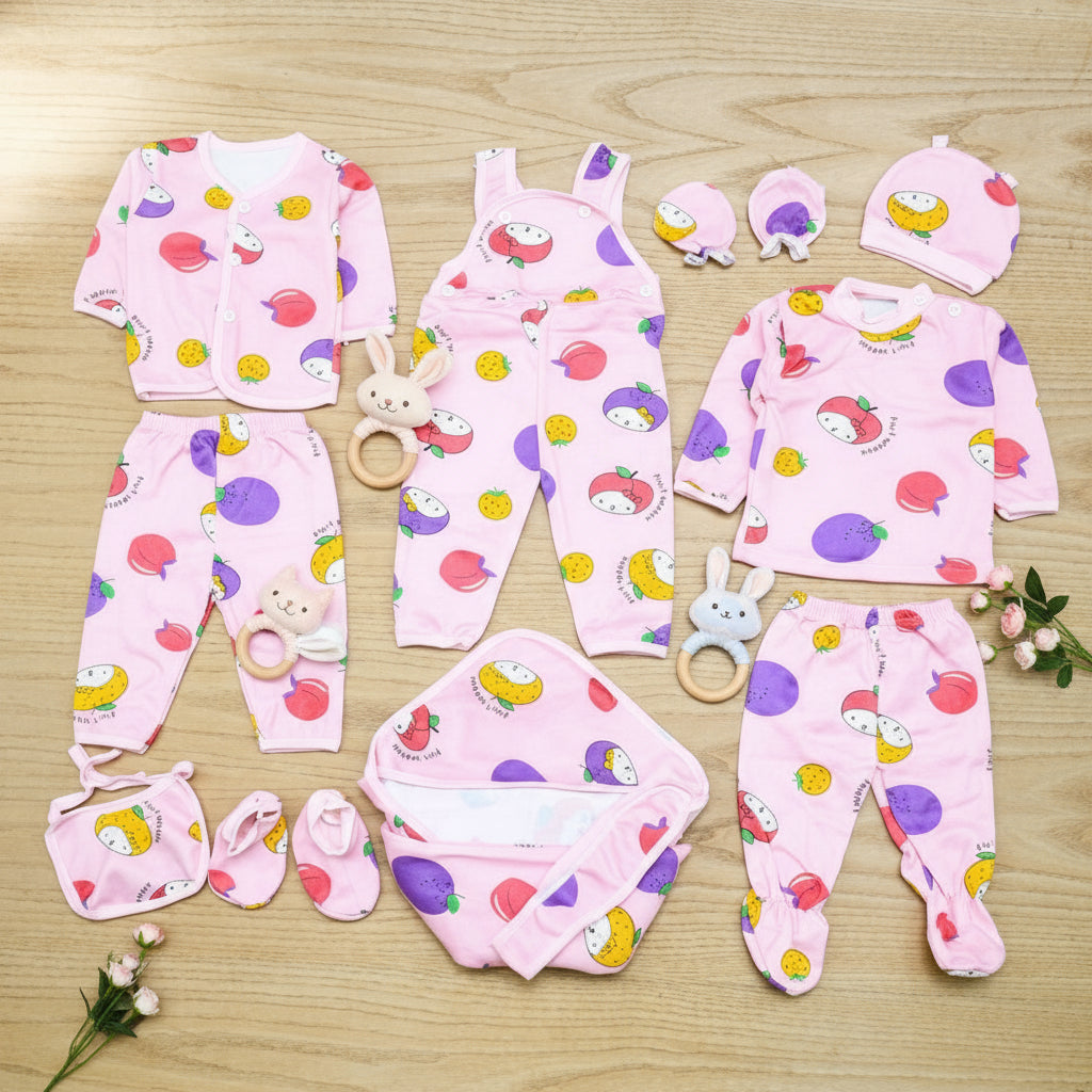 Collection of baby clothing items with colorful patterns on a wooden surface