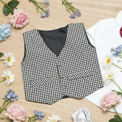 Black and white checkered vest on a wooden surface