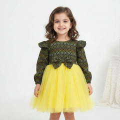 Green patterned top and yellow tutu skirt.