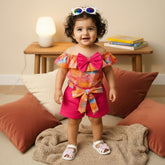 Colorful children's outfit with a top and shorts.