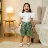 White shirt, green sequin shorts
