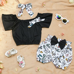 Black top, floral shorts, matching head band