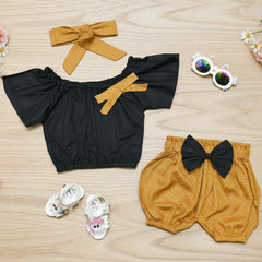Children's black top with yellow accents and mustard shorts