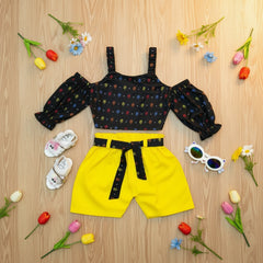 Black patterned crop top and yellow shorts