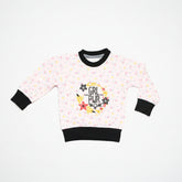 A pink girls' sweatshirt with full sleeves and a round neck. It features black text that reads 'Girls Power' and has a floral pattern with stars.