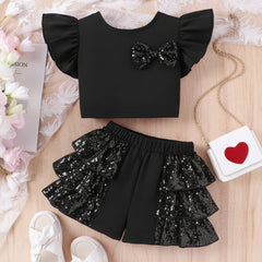 A baby toddler girl's dress with ruffle sleeves and sequin embellishments on the shorts, presented on a soft background alongside accessories.