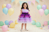 A multicolor multilayer ribbon bow knee-length frock with a round neckline and sleeveless design, predominantly in shades of purple.