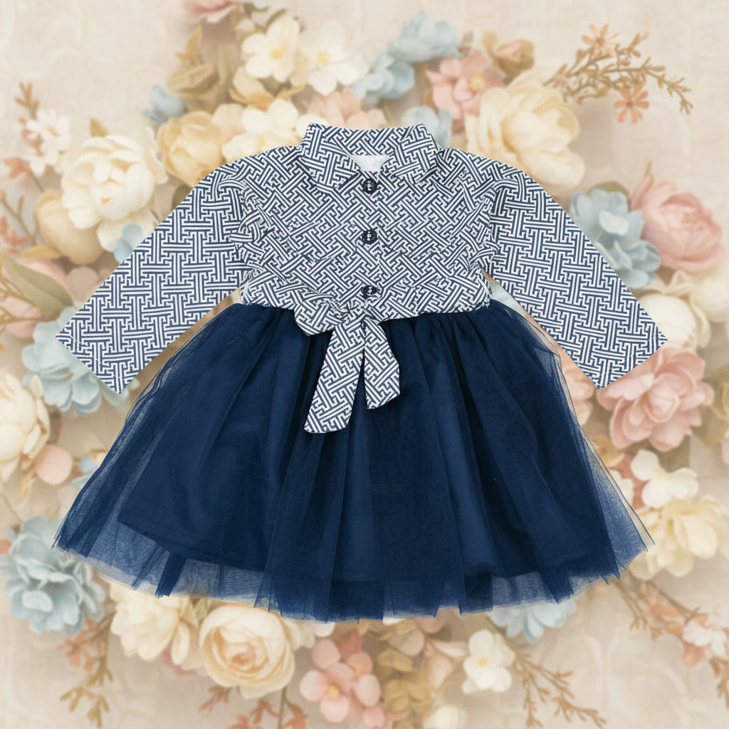 Children's outfit with a patterned shirt and navy blue tutu skirt on a white background