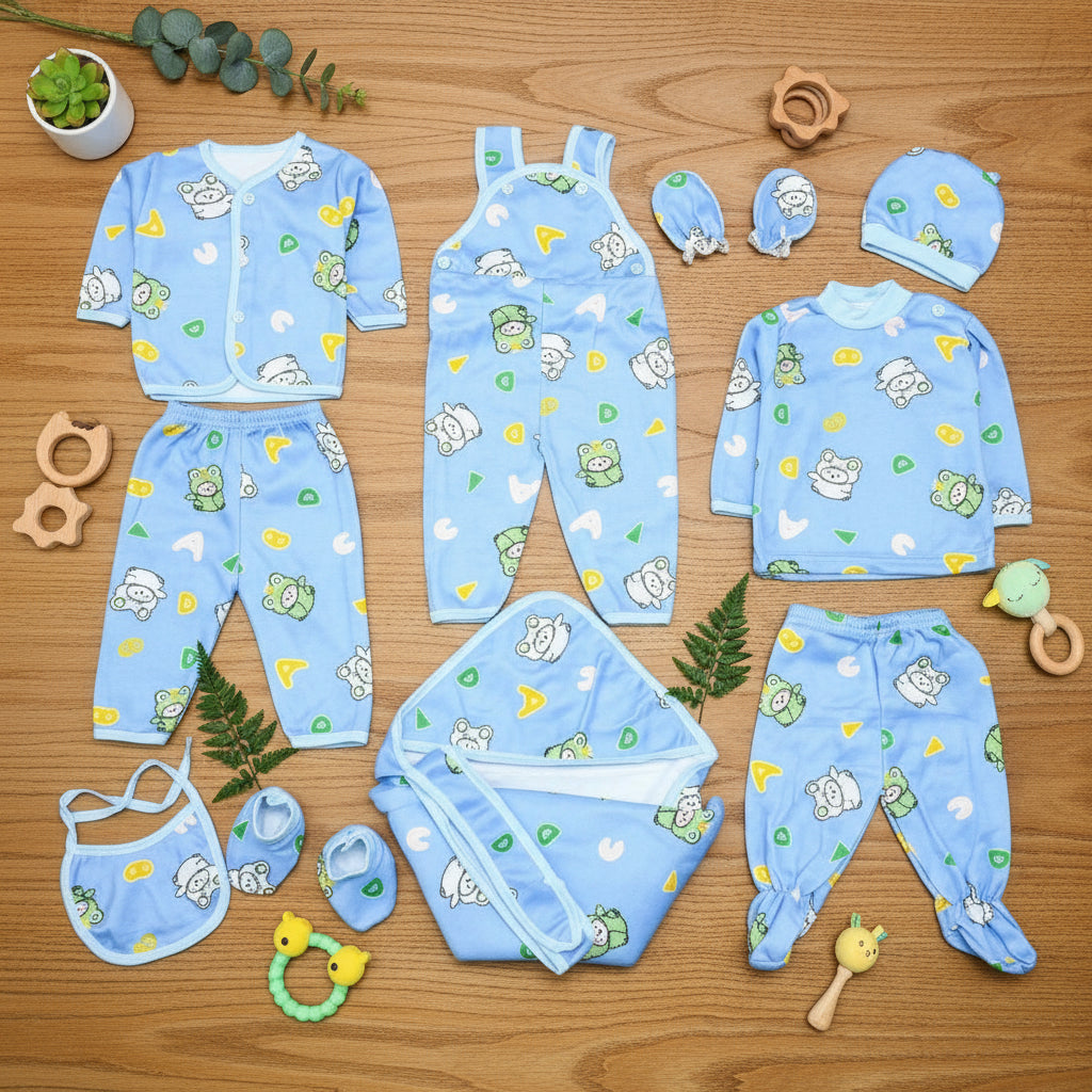 Collection of baby blue clothing items with cartoon patterns on a wooden surface