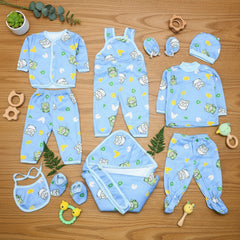 Collection of baby blue clothing items with cartoon patterns on a wooden surface