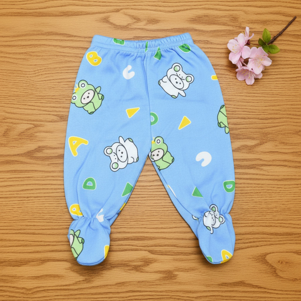Blue baby pants with cartoon patterns on a wooden surface