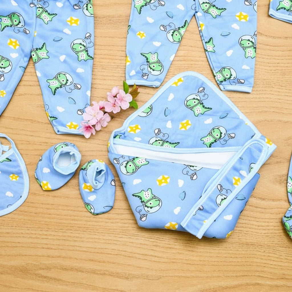 Baby clothing set with blue pattern on a wooden surface