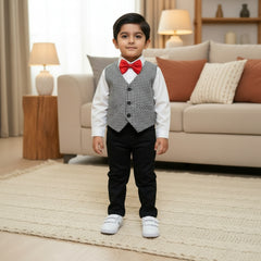 Children's outfit with white shirt, black pants, checkered vest, red bow tie.