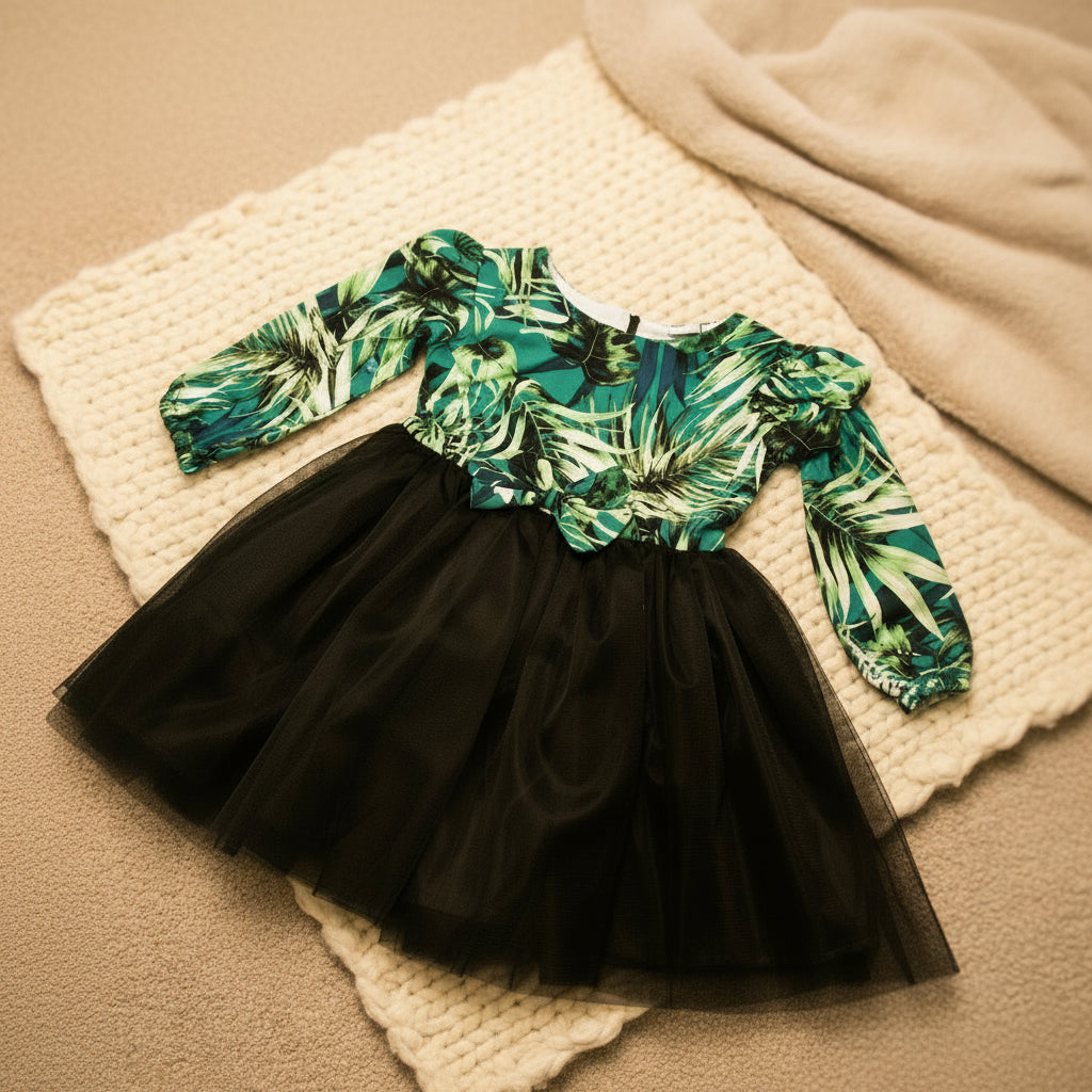 Black tulle skirt with a green leaf-patterned top.