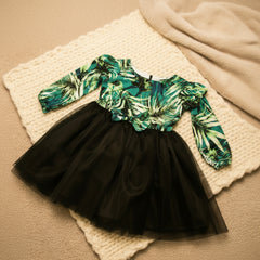 Black tulle skirt with a green leaf-patterned top.