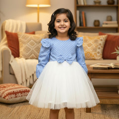 Blue polka dot blouse with white skirt.