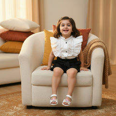 White shirt with black buttons, black shorts