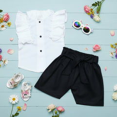 White shirt with black buttons, black shorts