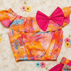 Colorful fabric with a large pink bow.
