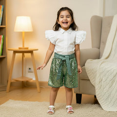 White shirt, green sequin shorts