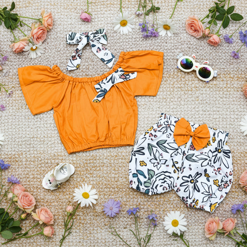 Children's outfit with mustard top, floral shorts, and head band