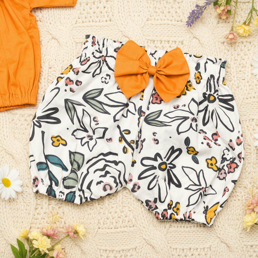 Floral-patterned baby bloomers with an mustard bow 