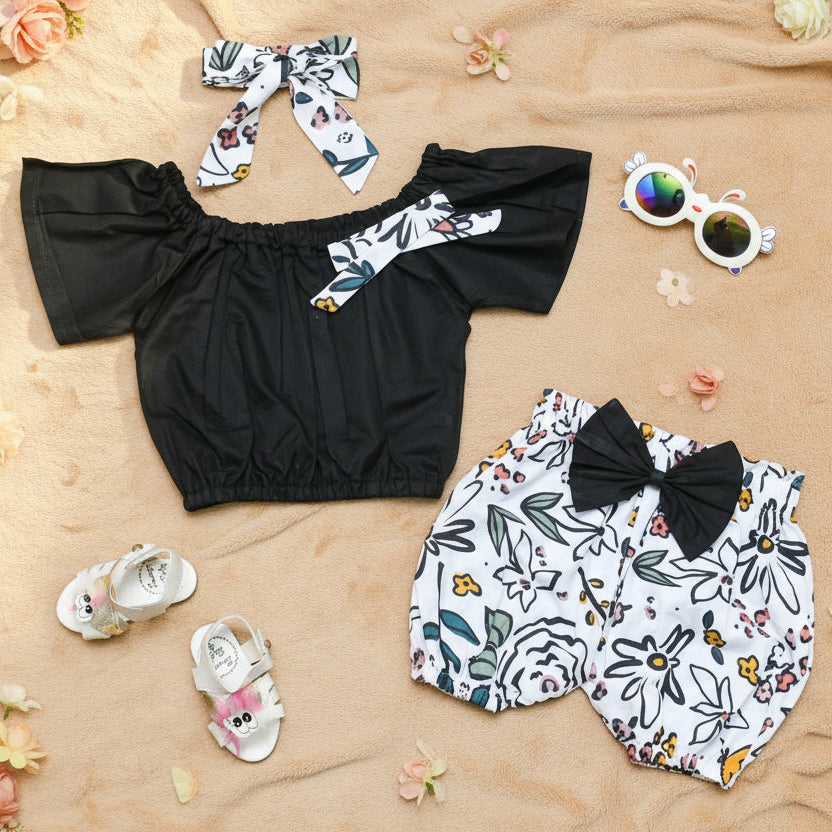 Black top, floral shorts, matching head band
