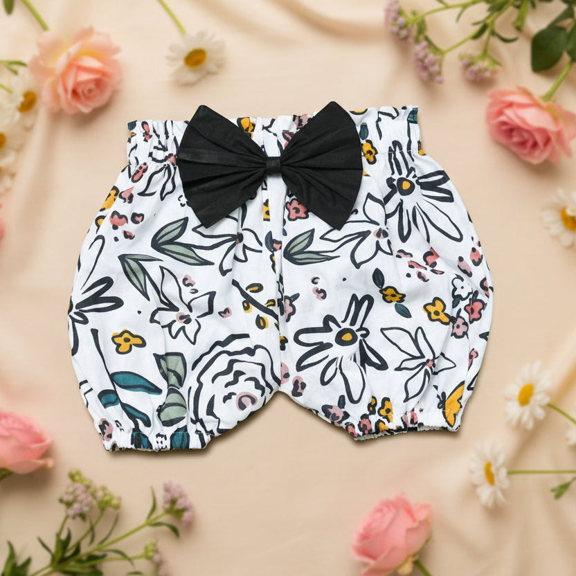 Floral-patterned baby bloomers with a large black bow 