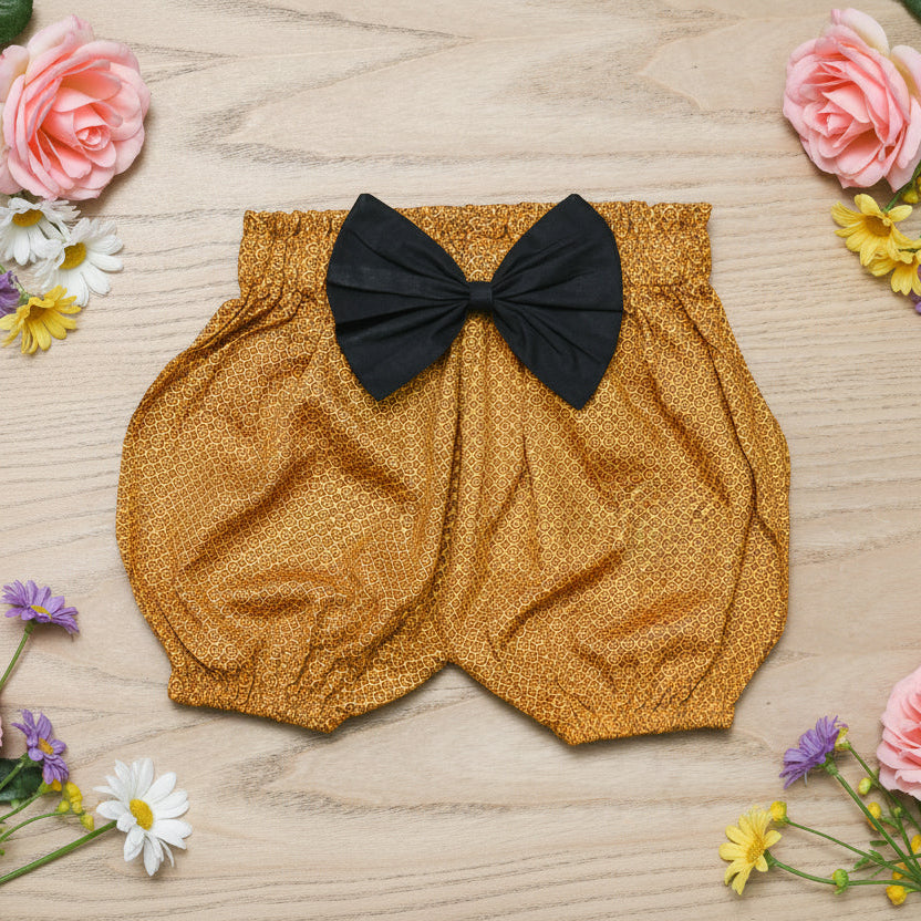 Yellow baby bloomers with a black bow 