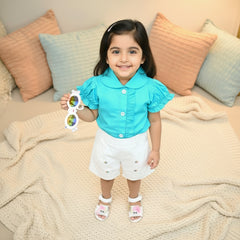 Young girl in a blue shirt and white shorts 