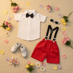 Children's clothing items including a white shirt, red shorts with suspenders