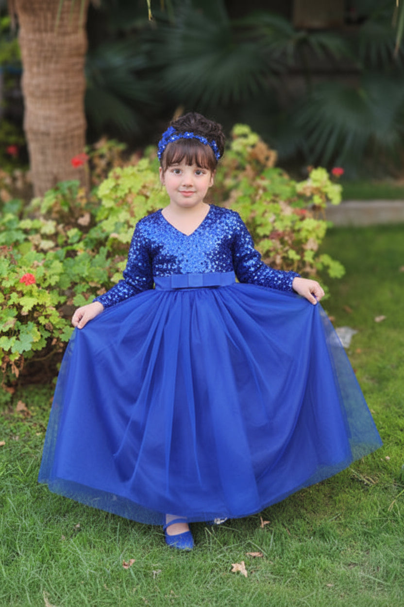Young girl in standing outdoors with greenery in the background