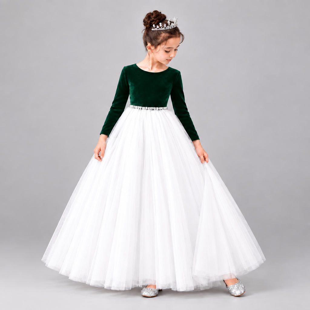 A young girl modeling a formal ball gown with a velvet long-sleeve bodice and a voluminous net skirt.