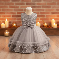 Grey sequin dress with a bow on a mannequin against a gray background